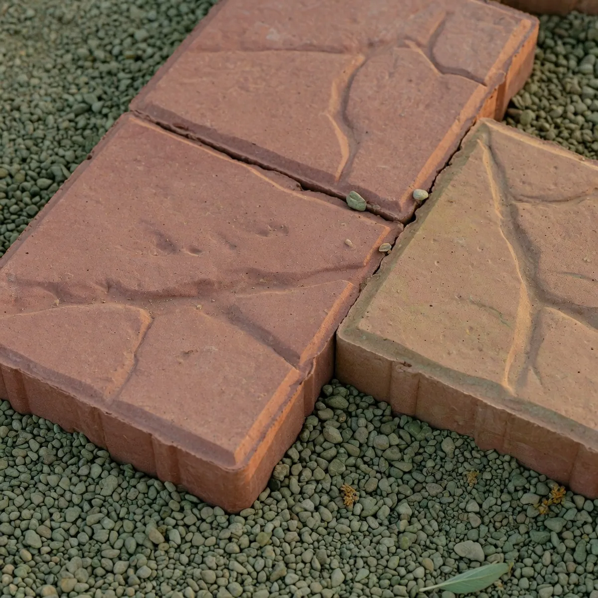 A close-up view of interlocking stamped concrete blocks with a subtle stone pattern.