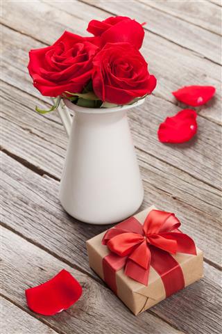 Red Rose Flowers In Pitcher