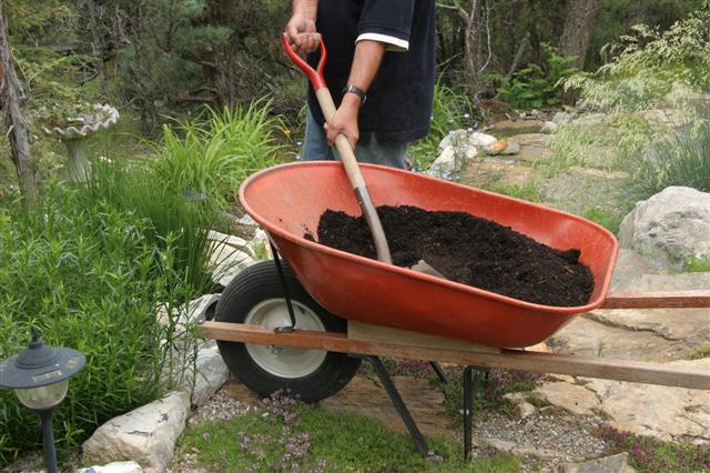 Soil In Wheelbarrow With Shovel