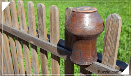 Earthenware pot on antique fence
